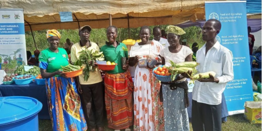 Farmers exhibiting their produce at a refugee settlement