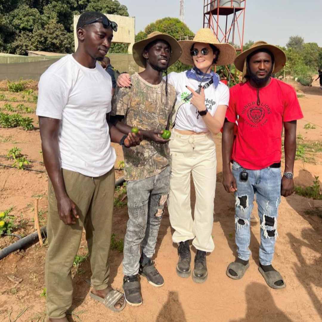 Jaimie Alexander and a group of farmers in The Gambia
